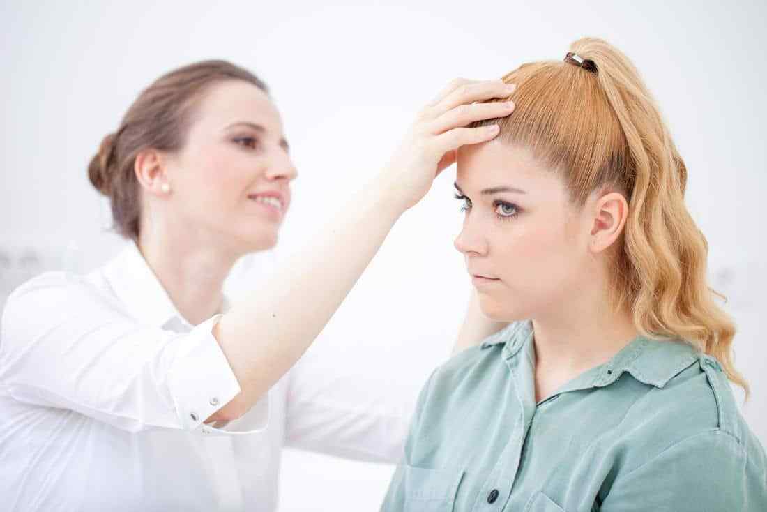 doctor-inspecting-a-patients-scalp-for-dandruff-or-dry-scalp.jpg